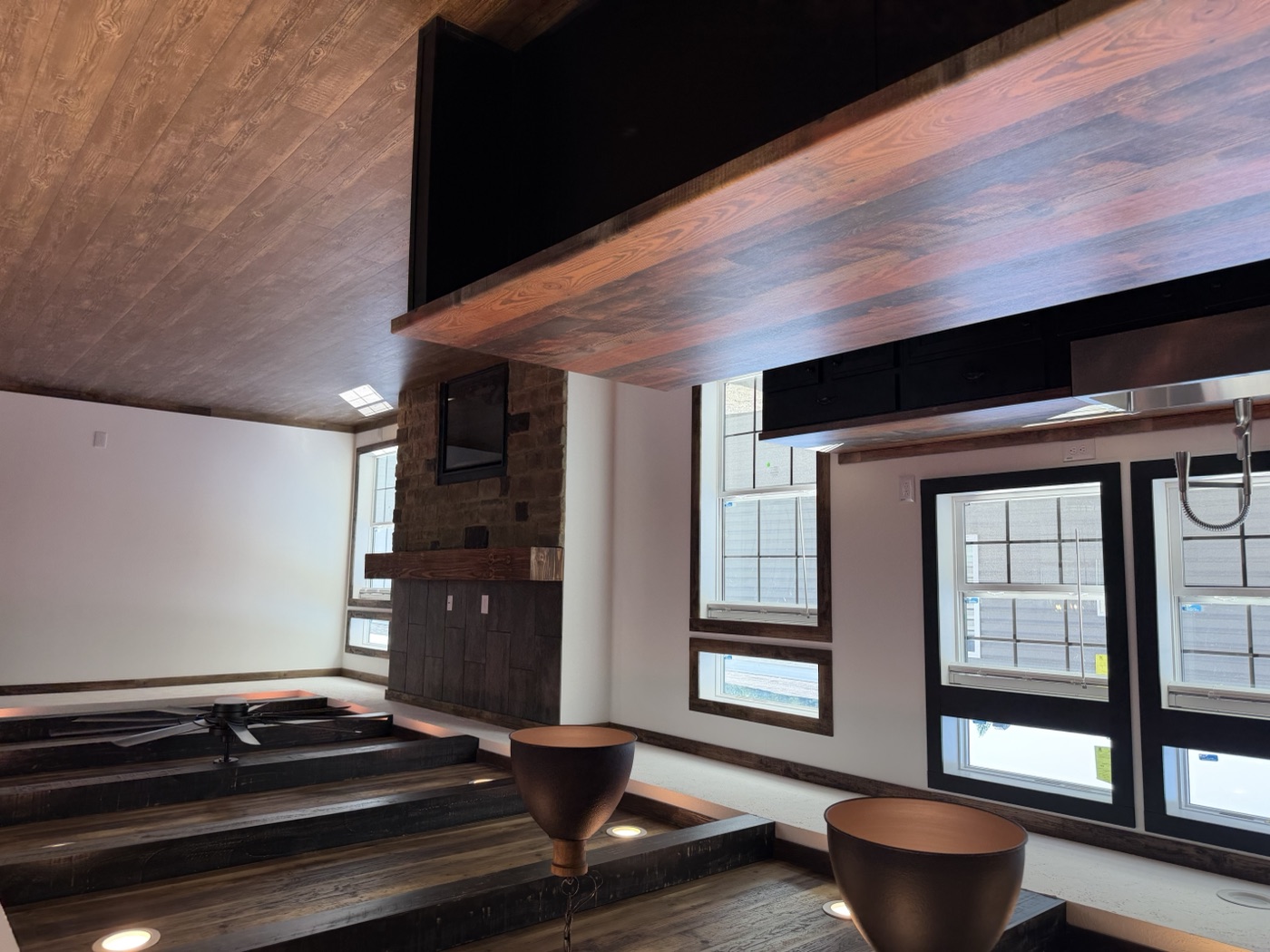 Finished open-concept kitchen with reclaimed-wood beam ceiling and butcher-block island